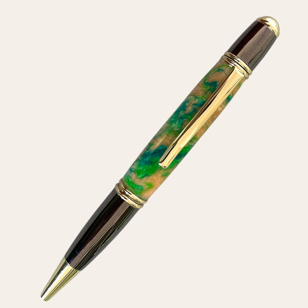 Introducing the Hand Turned Gatsby Refillable Pen - Harmony from Paul's Hand Turned Creations—a luxurious ballpoint with a glossy, multi-colored barrel featuring vibrant shades of orange, green, and gold. Its unique design boasts gold accents along the tip, clip, and cap, with a sleek metallic finish on the top and bottom sections.