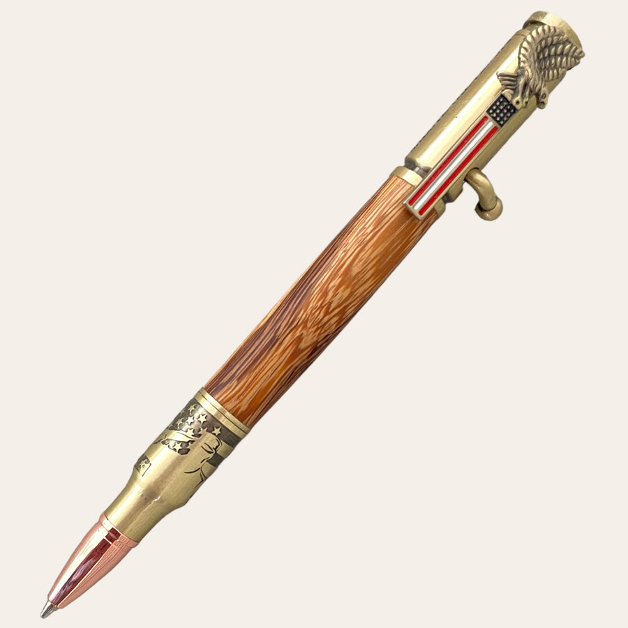 Picture shows a hand turned patriotic pen with a flag for the clip, a serviceman saluting near the nib, and light wood for the barrel.  Hand turned by Paul’s Hand Turned Crrarions. 