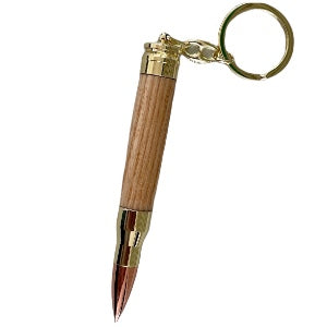 Keychain to resemble a bullet on a brass trim with white background made by Paul’s hand turned creations. 