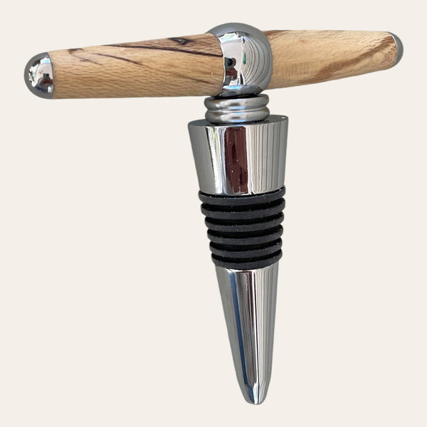 An Ambrosia Maple and metal wine stopper with a sleek T-shaped handle, crafted by Paul's Hand Turned Creations.