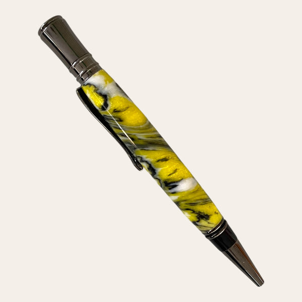 Side view of the Bumblebee resin executive pen made from black, white, and yellow resin with a swirl pattern. Hand turned by Paul’s Hand Turned Creations