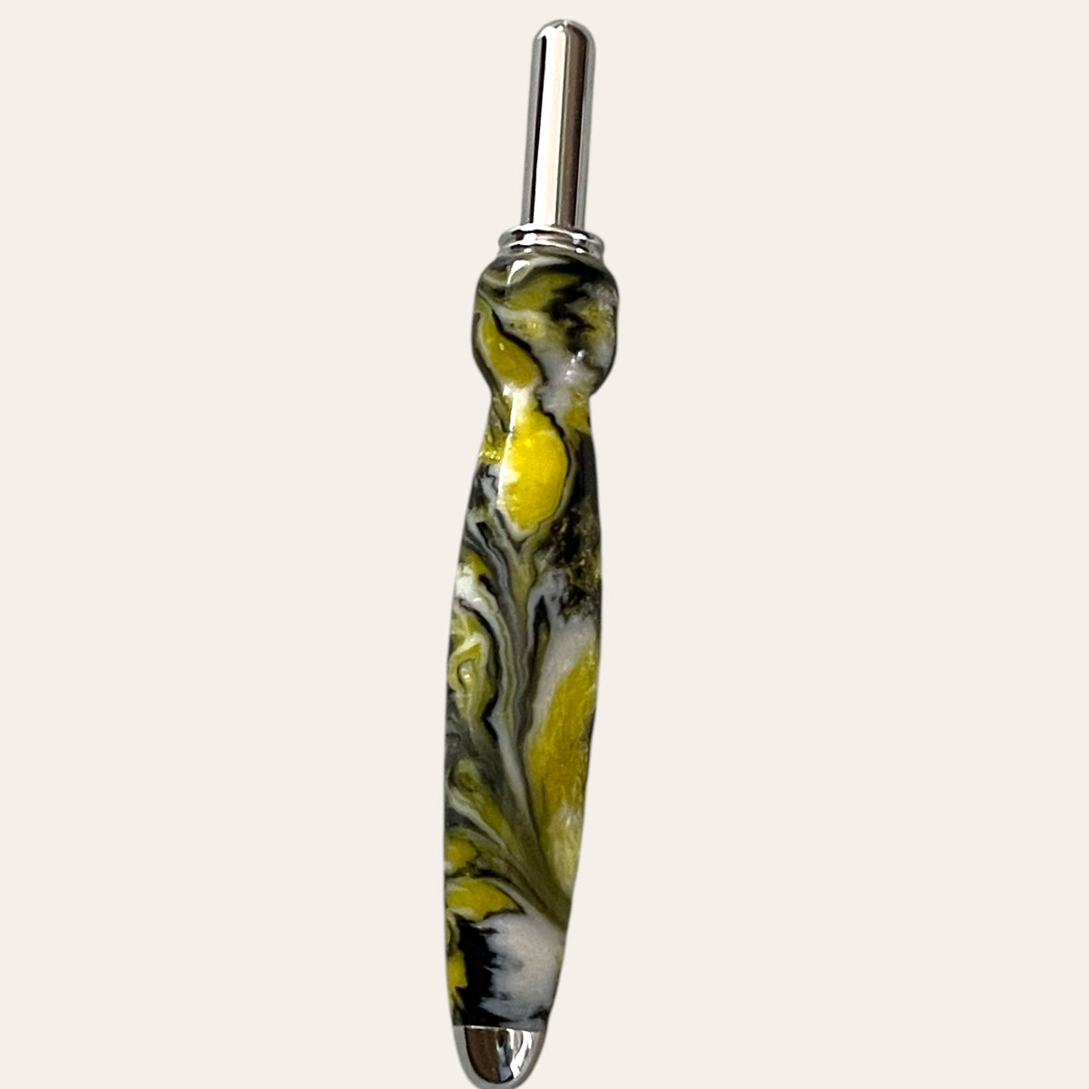 Hand-turned resin seam ripper with yellow, black swirls, and metallic accents.