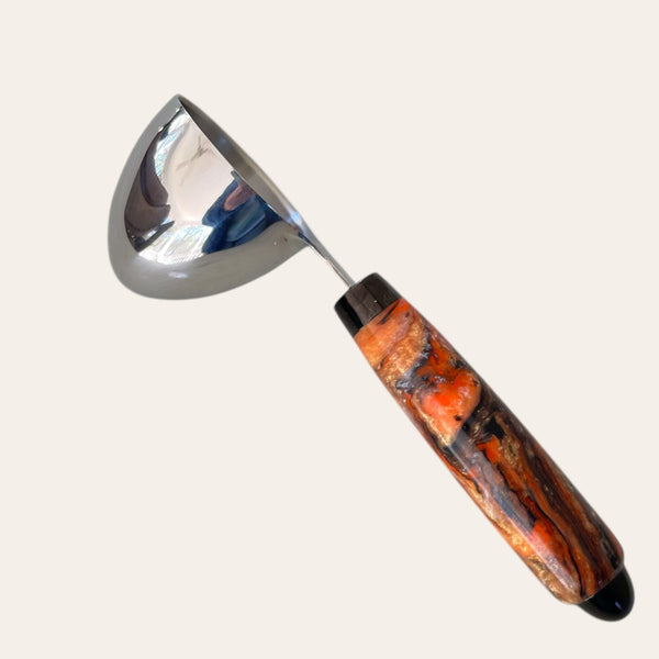 Orange & black resin coffee scoop by Paul's Creations on light background.