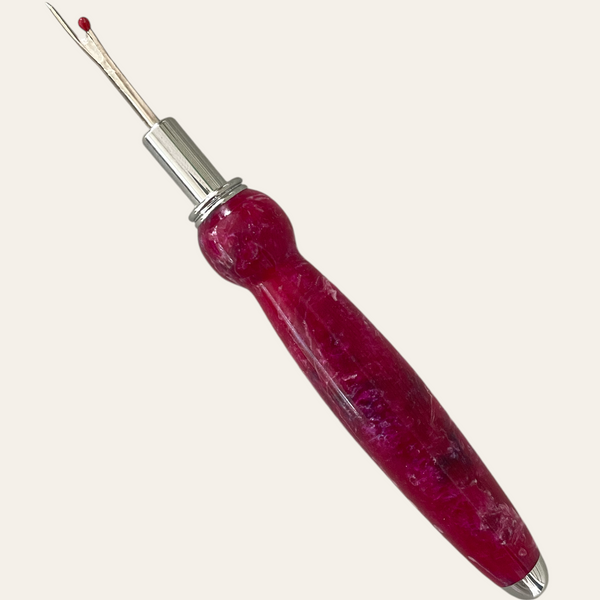 Another view of the cranberry seam ripper that shows the red and blue in the resin. Hand turned by Paul’s Hand Turned Creations. 