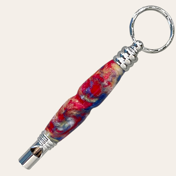 Secret compartment chrome keychain with safety whistle on the bottom.  Cyntrical shape so easy to hold in emergencies.  Colors from resin are blue, red, white, and yellow.  Turned by Paul’s Hand Turned Creations