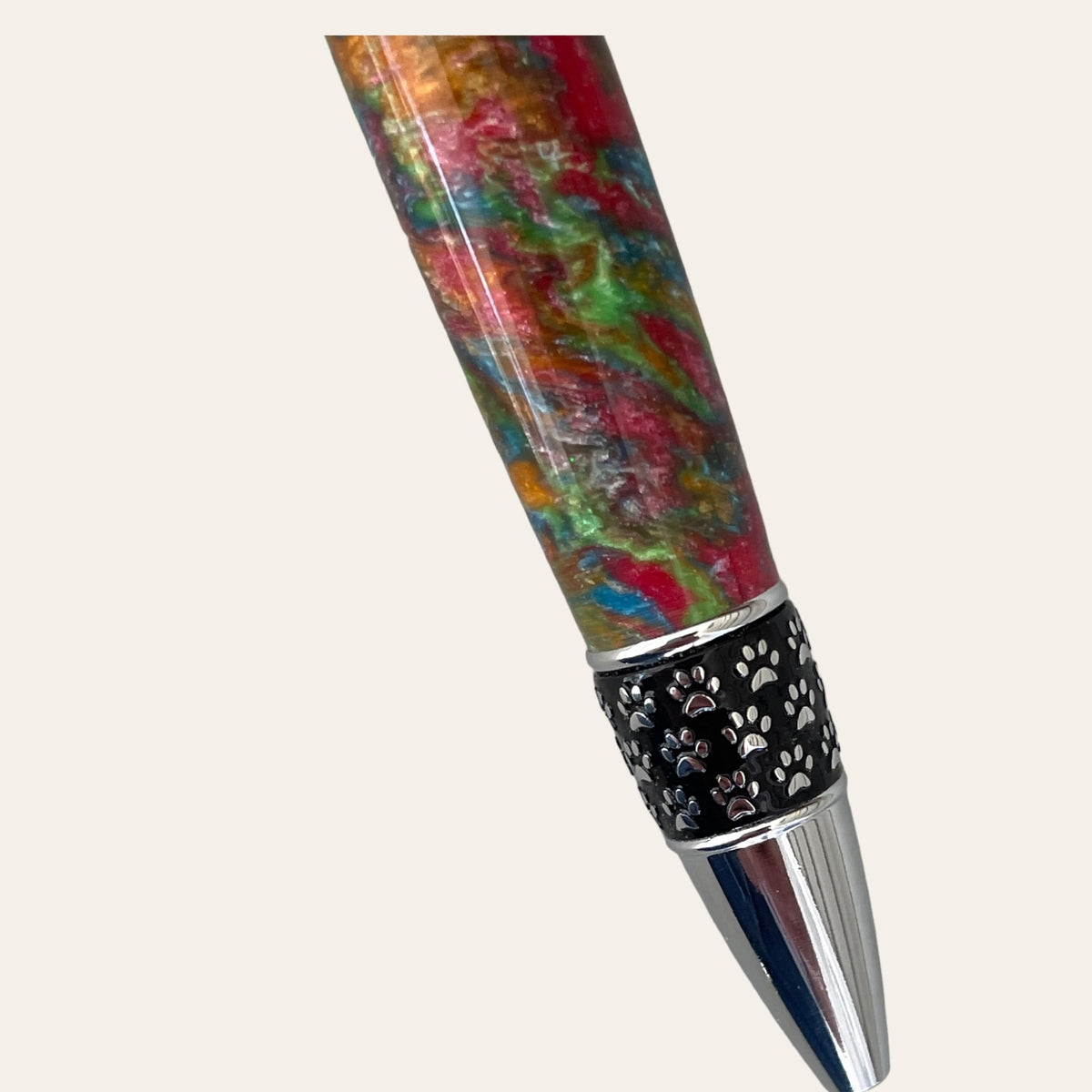 Discover the vibrant Hand Turned Cat Pen on Chrome Trim- Calico by Paul's Hand Turned Creations. This decorative fountain pen features a stunning marbled design in red, green, and blue with intricate silver detailing and a top clip. Complemented by black and silver accents near the nib and middle section, this pen beautifully stands out against any solid white background, reminiscent of a classic Calico twist pen.