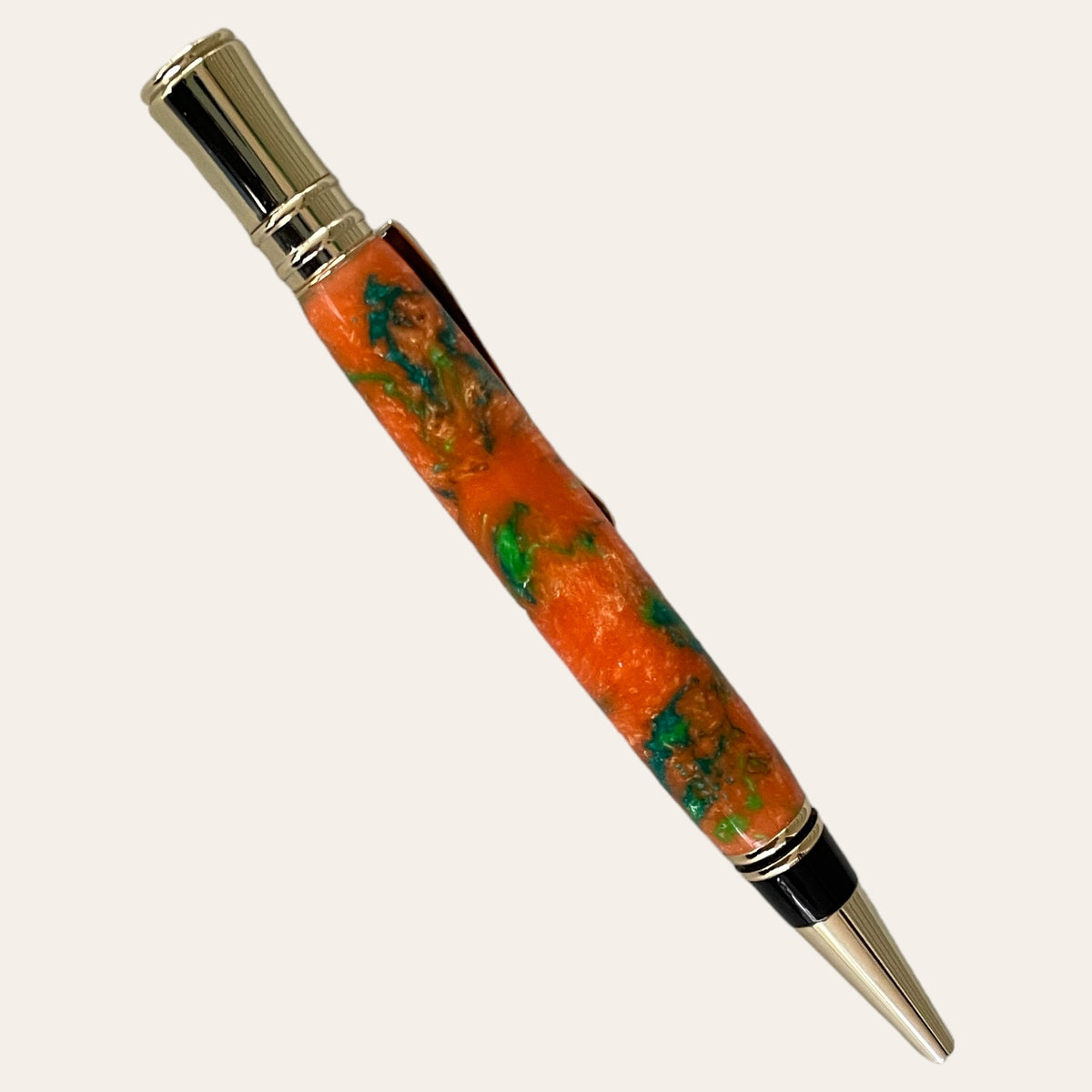 Resin Executive Pen With Chrome Trim - Harmony by Paul's Hand Turned Creations is a handcrafted writing instrument featuring a vibrant, marbled orange and green barrel, complemented by chrome accents on the clip, tip, and top. This pen boasts an ergonomic design and sleek elegance that make it both functional and visually appealing.