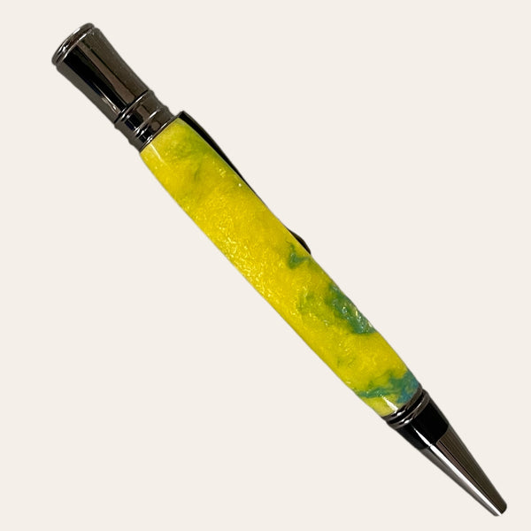 The Hand Turned Executive Pen With Gun Metal Trim - Sunbeam from Paul's Hand Turned Creations features a striking yellow and green marbled resin body, complemented by its metallic silver tip and clip. This handmade twist pen uses a Parker-style refill and is showcased diagonally against a plain, off-white background.