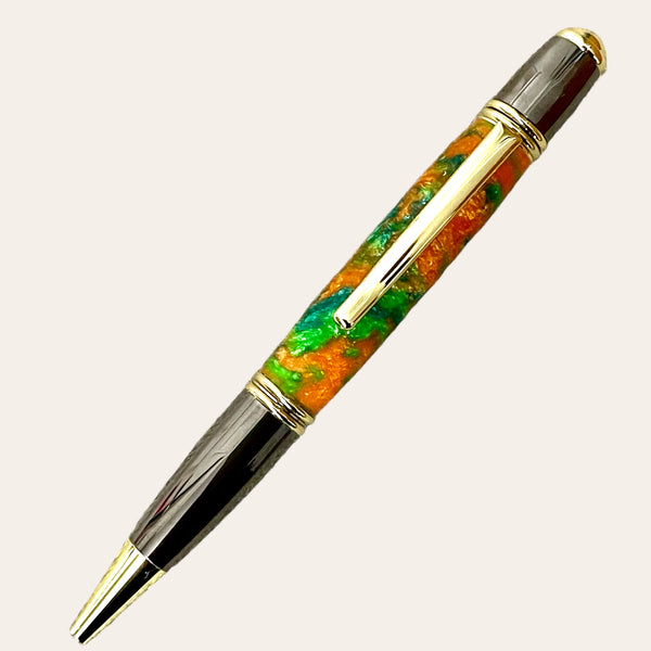 Introducing the Hand Turned Gatsby Refillable Pen - Harmony from Paul's Hand Turned Creations—a luxurious ballpoint with a glossy, multi-colored barrel featuring vibrant shades of orange, green, and gold. Its unique design boasts gold accents along the tip, clip, and cap, with a sleek metallic finish on the top and bottom sections.