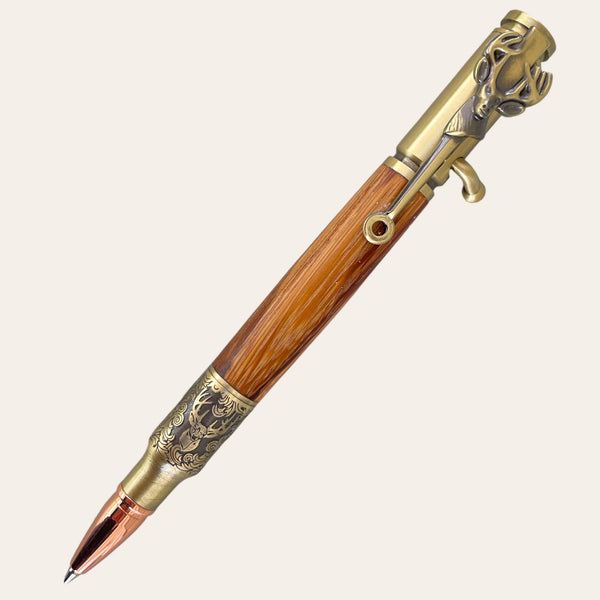 Discover the Deer Hunter Bolt Action pen from Paul's Hand Turned Creations—a luxurious, handcrafted writing instrument featuring a polished Zebrawood barrel and antique brass accents. This exquisite pen boasts an intricately designed clip shaped like a deer head and elegant engravings on the lower section, complete with a copper-colored nib.