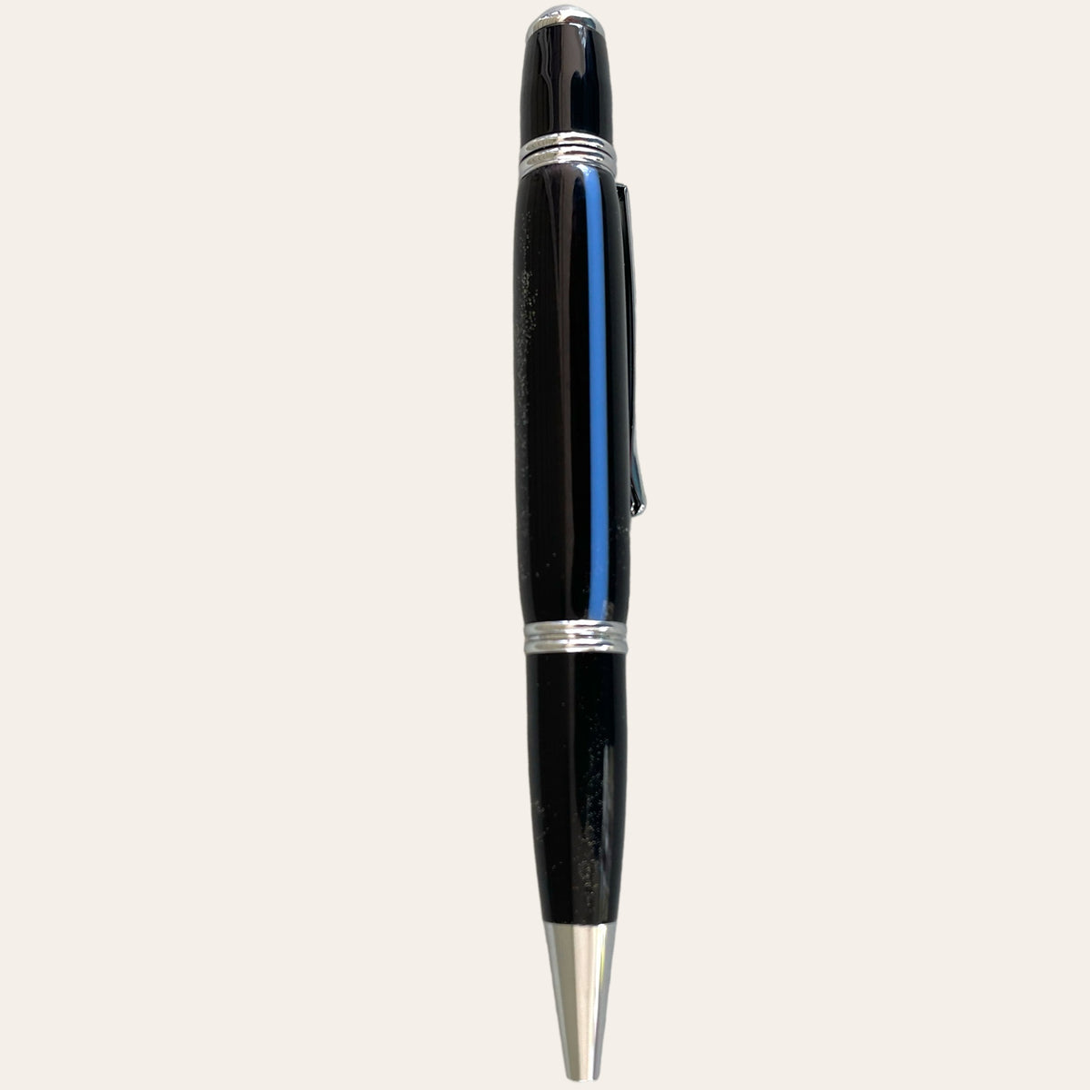 A sleek ballpoint pen with a black body, silver tip, clip, and trim, inspired by the sophistication of Paul's Hand Turned Creations' Hand Turned Thin Blue Line Gatsby Pen With Chrome Trim.