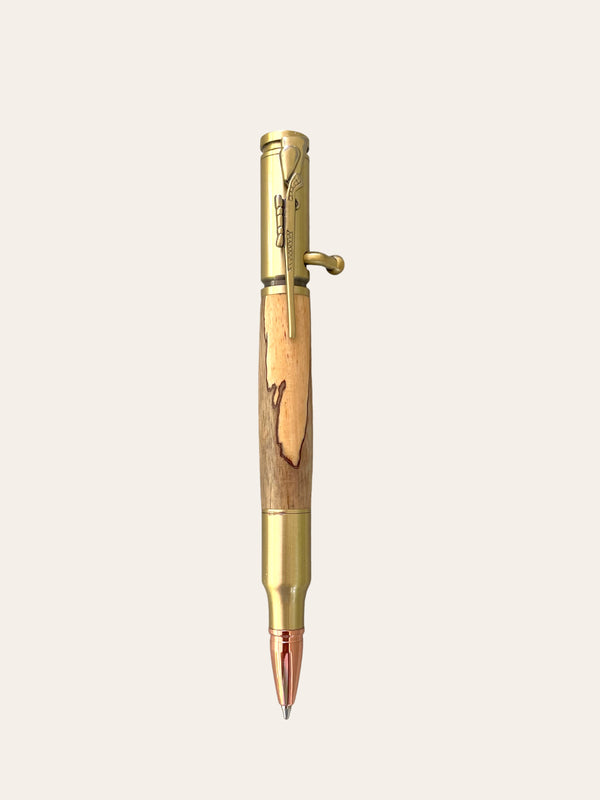 The 30 Caliber Rifle Bolt Action Pen with Antique Brass - Spalted Tamarind from Paul's Hand Turned Creations is perfect for hunting enthusiasts. This ballpoint pen features a unique mechanism with a lever near the top for retracting the tip. The wood has a natural, rustic look, and the brass components add a vintage touch.