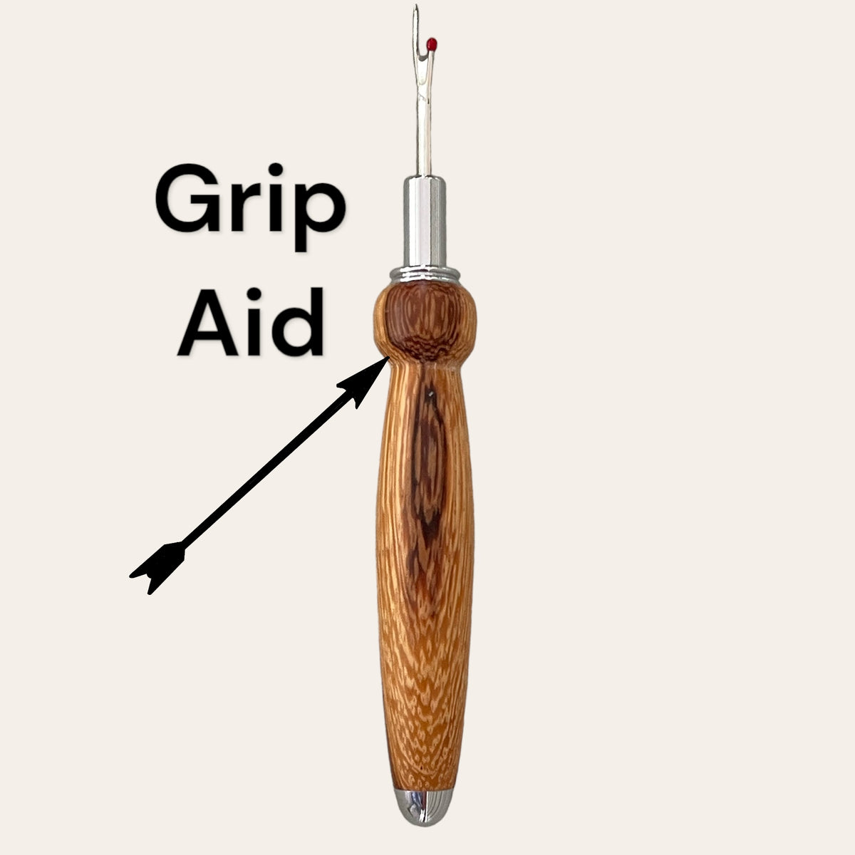 The Zebrawood Hand Turned Single Blade Seam Ripper by Paul's Hand Turned Creations, featuring a stainless steel blade, a zebrawood handle, and a grip aid attachment, is shown against a plain background. The text "Grip Aid" with arrows points to the middle portion of this essential sewing tool.