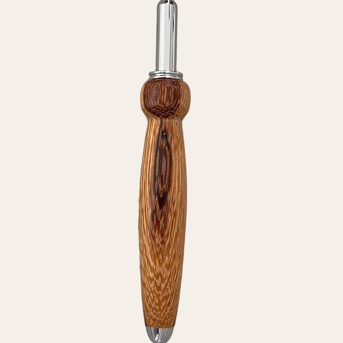 The Zebrawood Hand Turned Single Blade Seam Ripper by Paul's Hand Turned Creations boasts a finely crafted, intricately designed wooden body with a detailed wood grain pattern. Reminiscent of a high-quality sewing tool, it features a polished metal tip and an ergonomic handle for comfortable use.