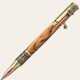 Introducing the Bald Eagle Bolt Action Hand Turned Pen with Bethlehem Olive Wood by Paul's Hand Turned Creations. This handcrafted pen showcases patriotic elements, featuring a detailed eagle and the American flag. The wooden barrel, made from exquisite Bethlehem Olive Wood, boasts intricate grain patterns and is enhanced with antique brass finish accents and a capped copper tip. A true symbol of American pride in every stroke.