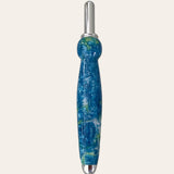 A uniquely designed seam ripper with a blue and green marbled resin handle, featuring a rounded grip and silver metal accents on both ends. This tool, reminiscent of a finely crafted pen, stands vertically against a plain background. The product is known as the 