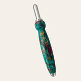 The Royal Jewels Resin Single Blade Seam Ripper by Paul's Hand Turned Creations is a handheld sewing tool featuring a colorful, patterned handle that is predominantly green with swirls of red, yellow, and purple. It boasts a shiny silver stainless steel blade and an ergonomically shaped handle with a bulbous end for a comfortable grip.