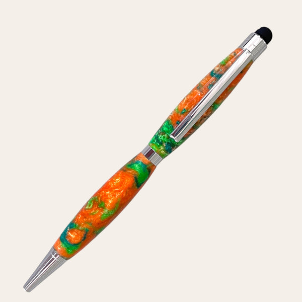 An intricately designed Resin Refillable Stylus Pen Chrome Trim - Harmony from Paul's Hand Turned Creations, featuring a marbled orange and green texture with silver accents. This stylish pen is refillable, with a sleek, polished finish and a black tip at one end, complemented by a silver clip.