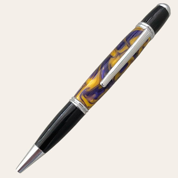 The "Purple with Yellow Gatsby Pen" by Paul's Hand Turned Creations is a handcrafted fountain pen boasting a unique design. It features vibrant purple and yellow swirls on the barrel, complemented by elegant silver accents and a sleek black cap and tip. This refillable pen is both stylish and functional.