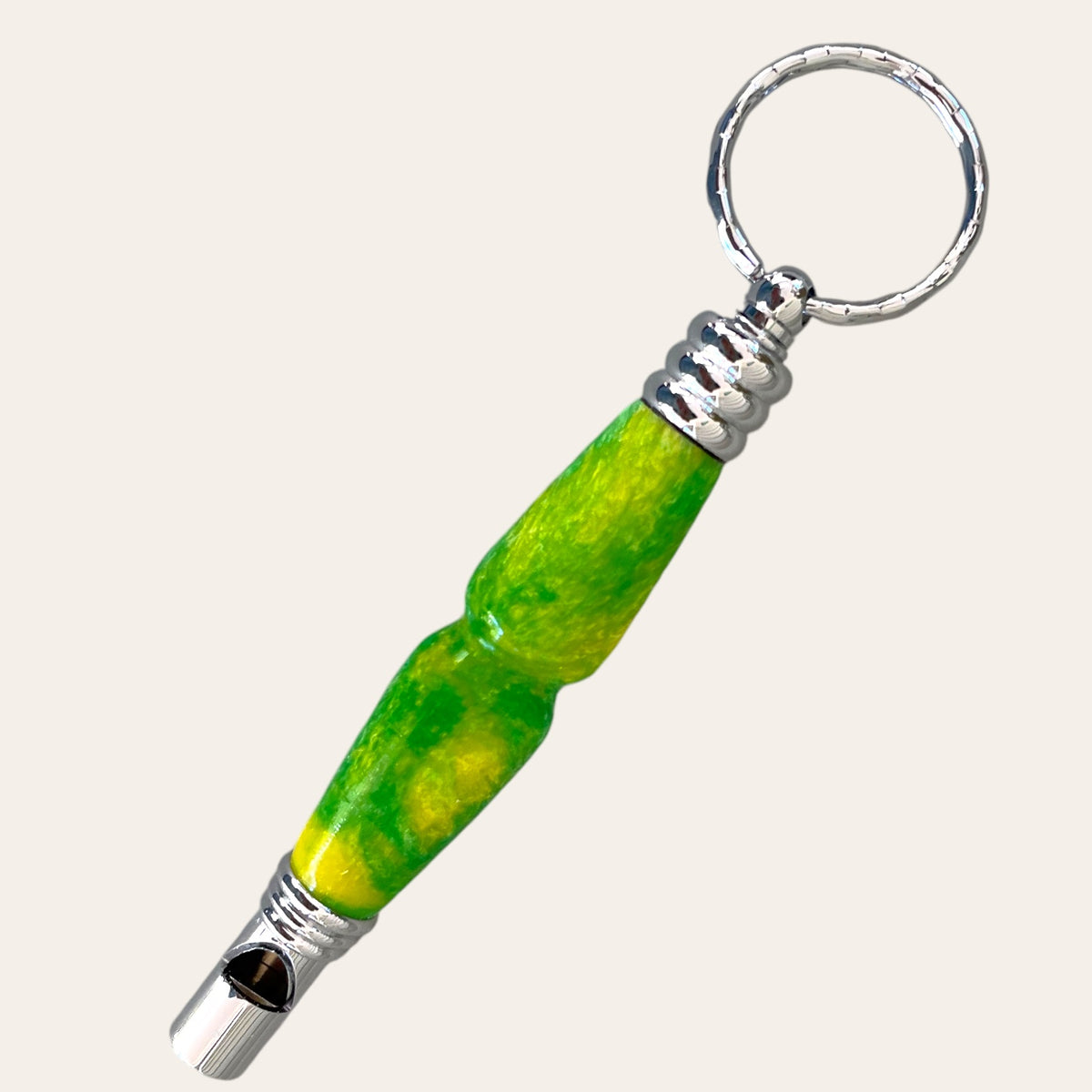 
Hand-turned secret compartment whistle made from resin in bright green and yellow tones. The top unscrews to reveal a small storage space inside the barrel. Crafted by Paul's Hand Turned Creations.