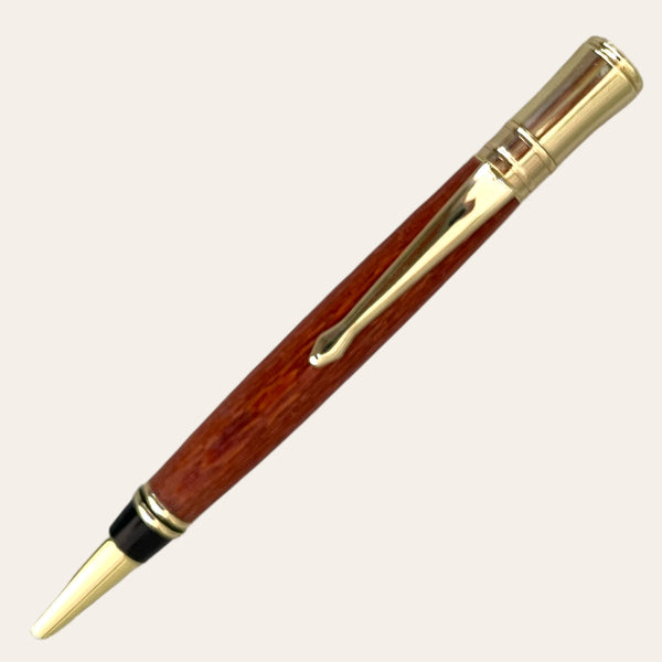 Introducing the "Letter Opener with Executive Pen on Gold Trim - Exotic Leopard Wood" by Paul's Hand Turned Creations. This elegant executive pen features a wooden barrel crafted from exquisite Leopardwood and is adorned with gold-colored accents, including the tip, pocket clip, and upper section. The hand-turned design exudes classic sophistication, making it perfect for formal writing occasions.