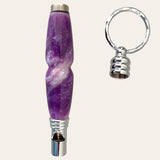 Introducing the Lilac Resin Secret Compartment Key Chain by Paul's Hand Turned Creations, a stylish safety whistle in shades of purple and white, complete with a detachable keychain ring and a convenient secret compartment.