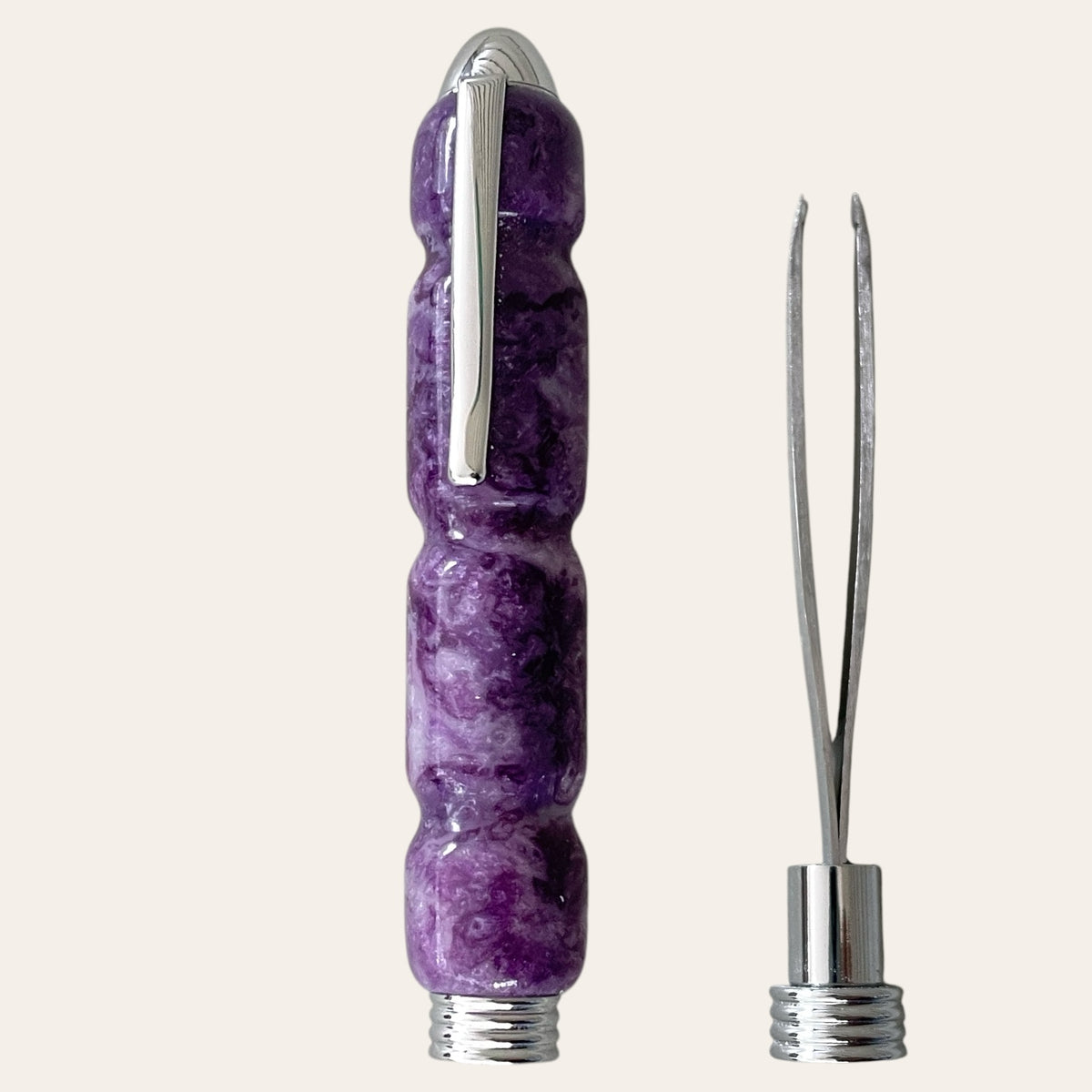 Lilac Resin Case & Tweezer by Paul's Hand Turned Creations, near a double-pronged slant tipped stainless steel tweezer 