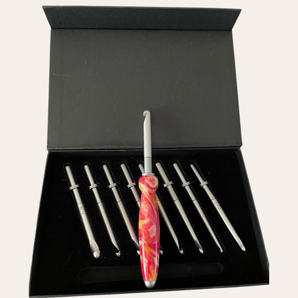 Box set showing the hand-turned handle with nine interchangeable crochet hooks in a black box.  Made by Paul’s Hand Turned Creations. 