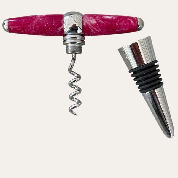 Magenta resin hand-turned T-handle corkscrew and wine topper adorned with black rubber rings from Paul's Hand Turned Creations on a light background.