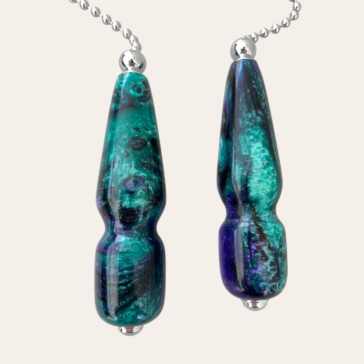 Two sleek Mysterious resin pulls on chrome chains by Paul's Creations against a light background.