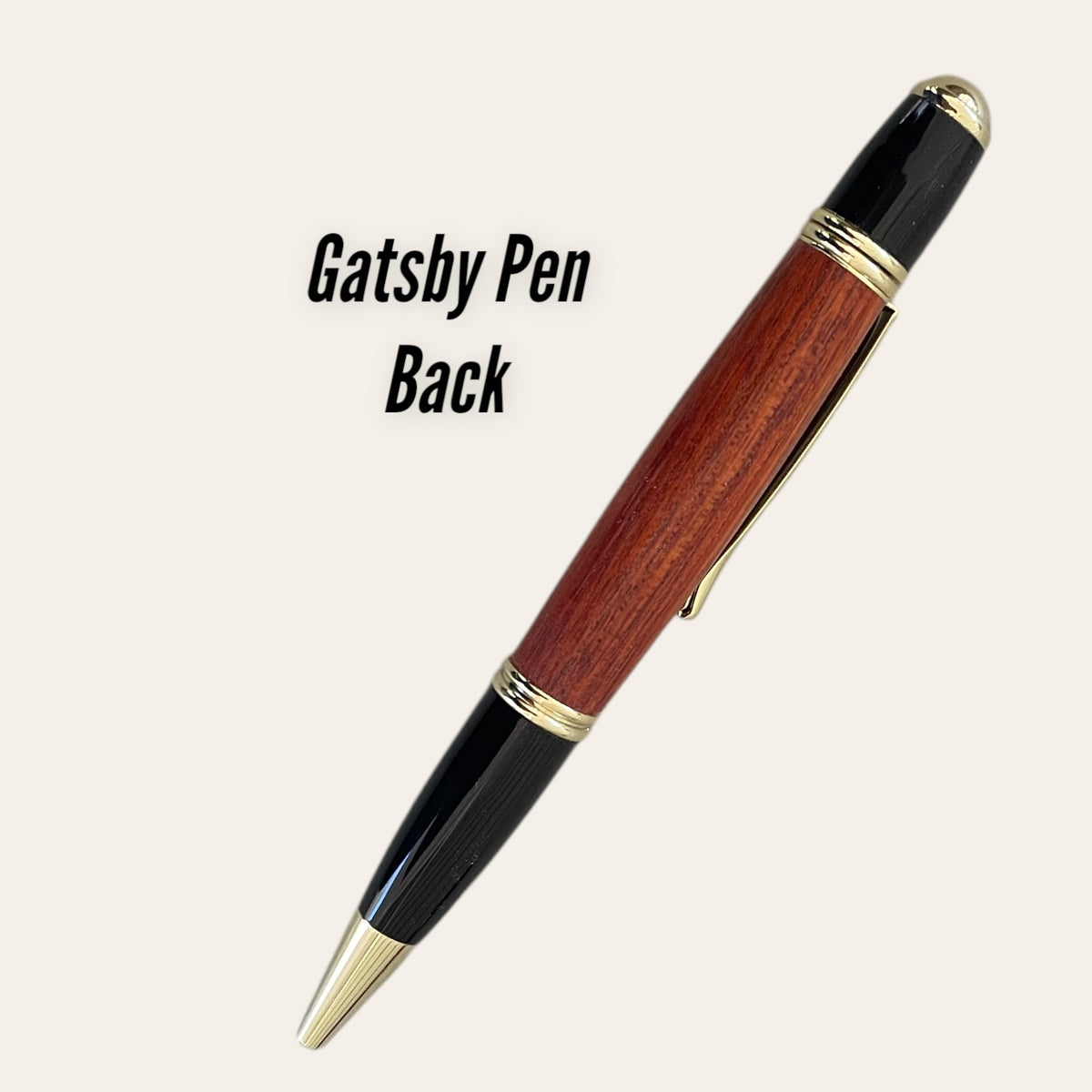 Paul's Hand Turned Creations' Padauk wood Gatsby pen with black accents and gold trim.