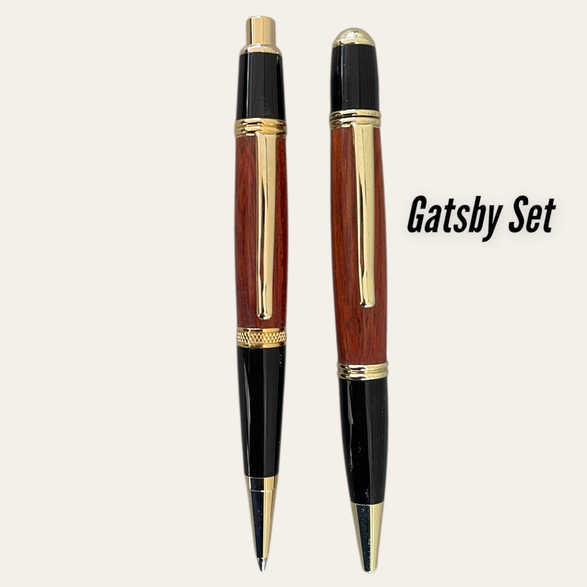 The Gatsby Pen and Pencil Set by Paul's Hand Turned Creations features gold accents and Padauk wood grain.