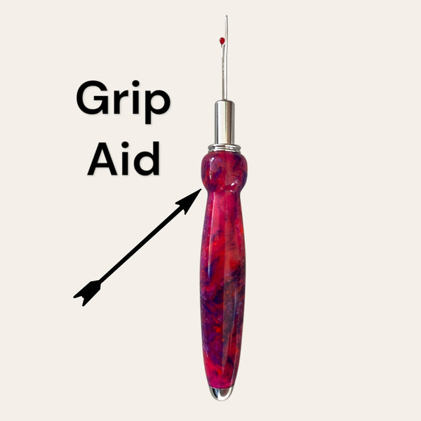 Razzle Dazzle red seam ripper by Paul's; ergonomic resin handle with "Grip Aid" label.