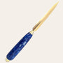 Featuring a gold blade and an elegantly marbled royal blue resin handle, the Resin Hand Turned Letter Opener by Paul's Hand Turned Creations stands out as a stunning piece against a plain background, making it a truly unique gift option.