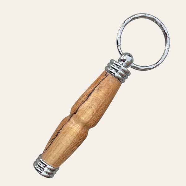 Spalted maple keychain with silver accents and a secret compartment, by Paul's Hand Turned Creations.