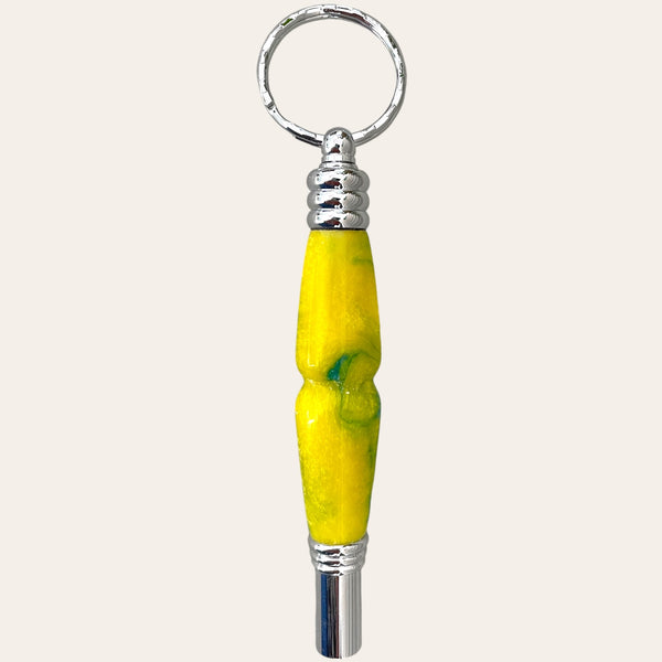 The Sunbeam Secret Compartment Key Chain with Safety Whistle by Paul's Hand Turned Creations is a stylish keychain in yellow and green, featuring a metallic ring and cap. It comes with an integrated safety whistle and a secret compartment for added convenience.