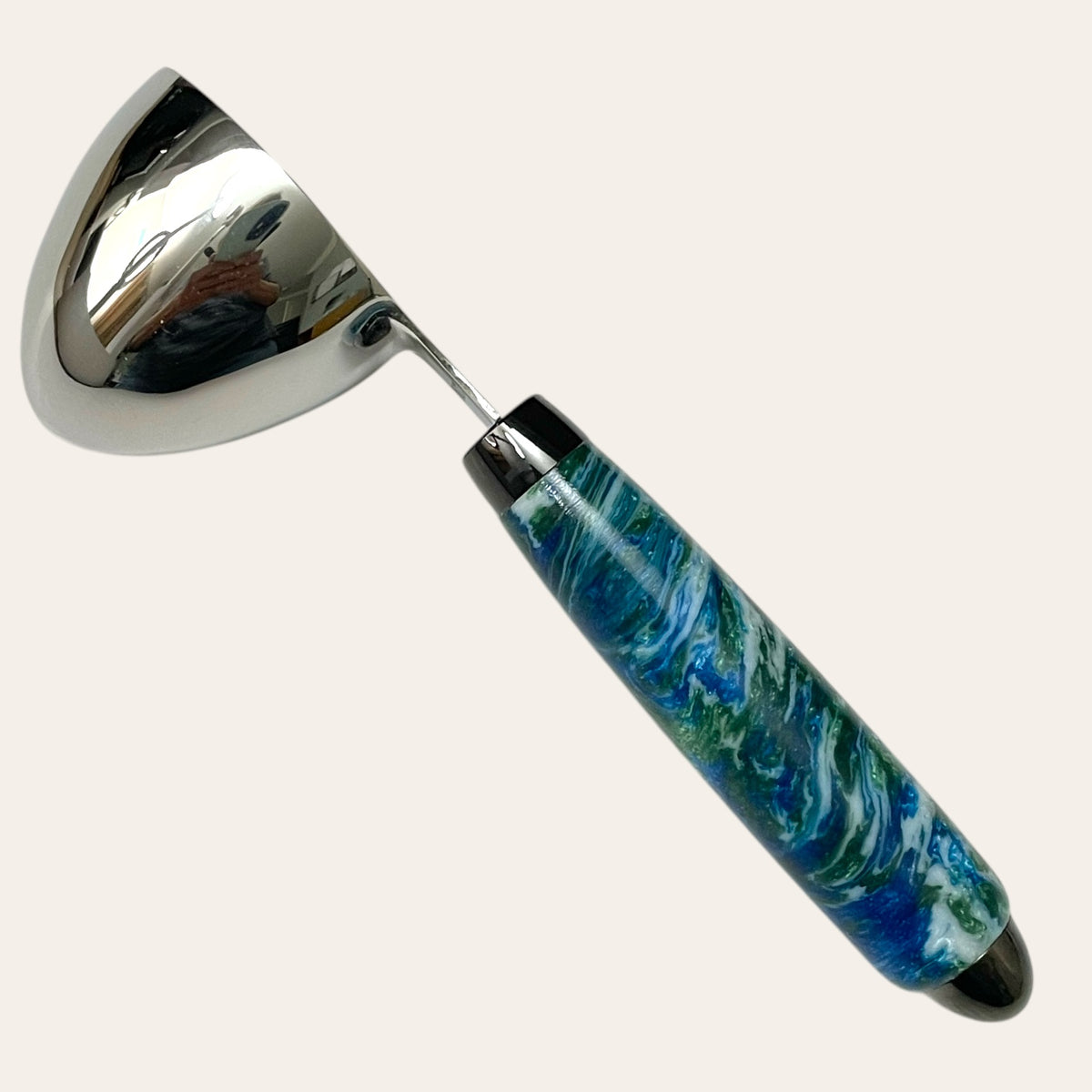 Custom Under The Sea resin coffee scoop by Paul's Hand Turned Creations. The colors are blue, green, and white and are in a swirl pattern. 