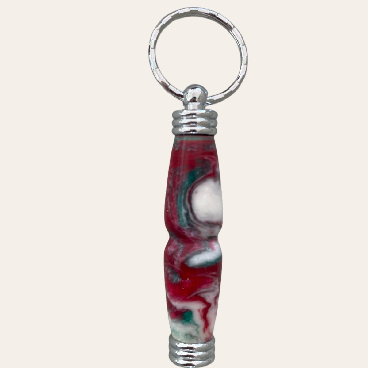 secret compartment keychain made from resin and called nougat. coloring is red , white, and green. Paul's Hand Turned Creations