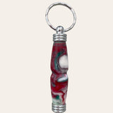 secret compartment keychain made from resin and called nougat. coloring is red , white, and green. Paul's Hand Turned Creations